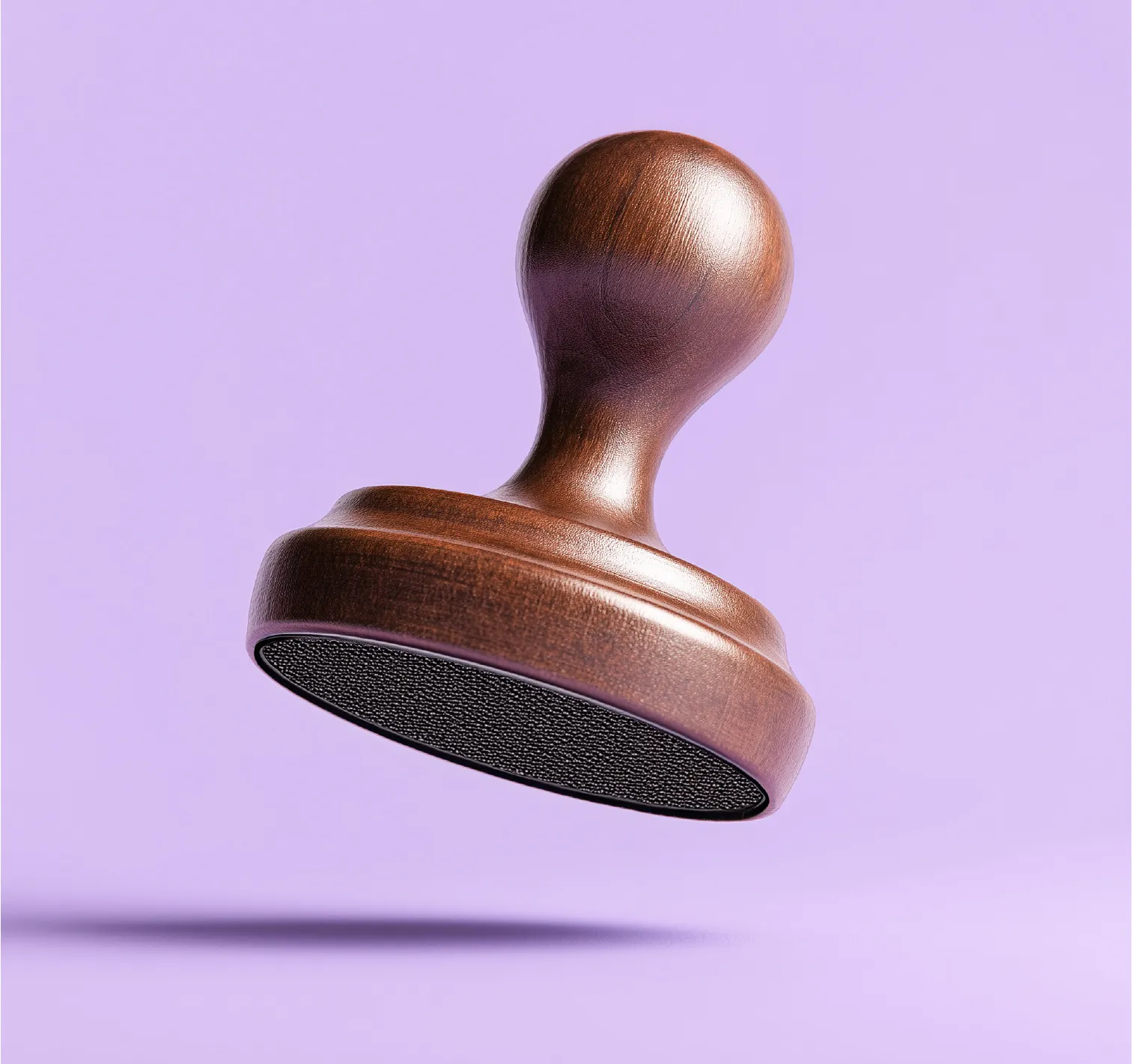 A wooden audit stamp resting on a soft lavender background